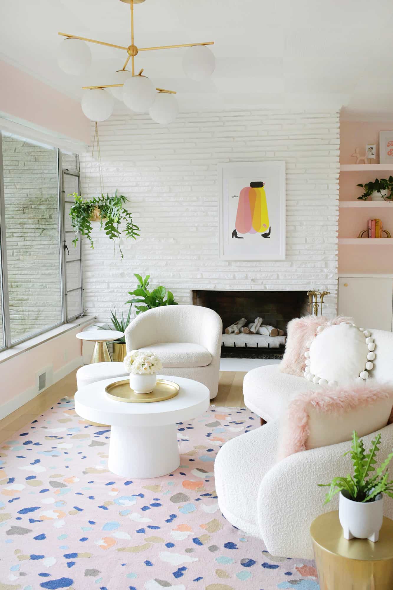 view of living room with white stone fireplace and chair and couch in front of it