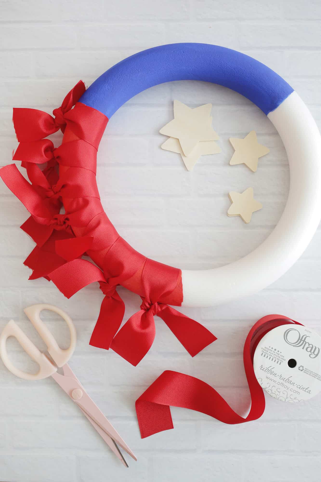 tied red ribbons around wreath