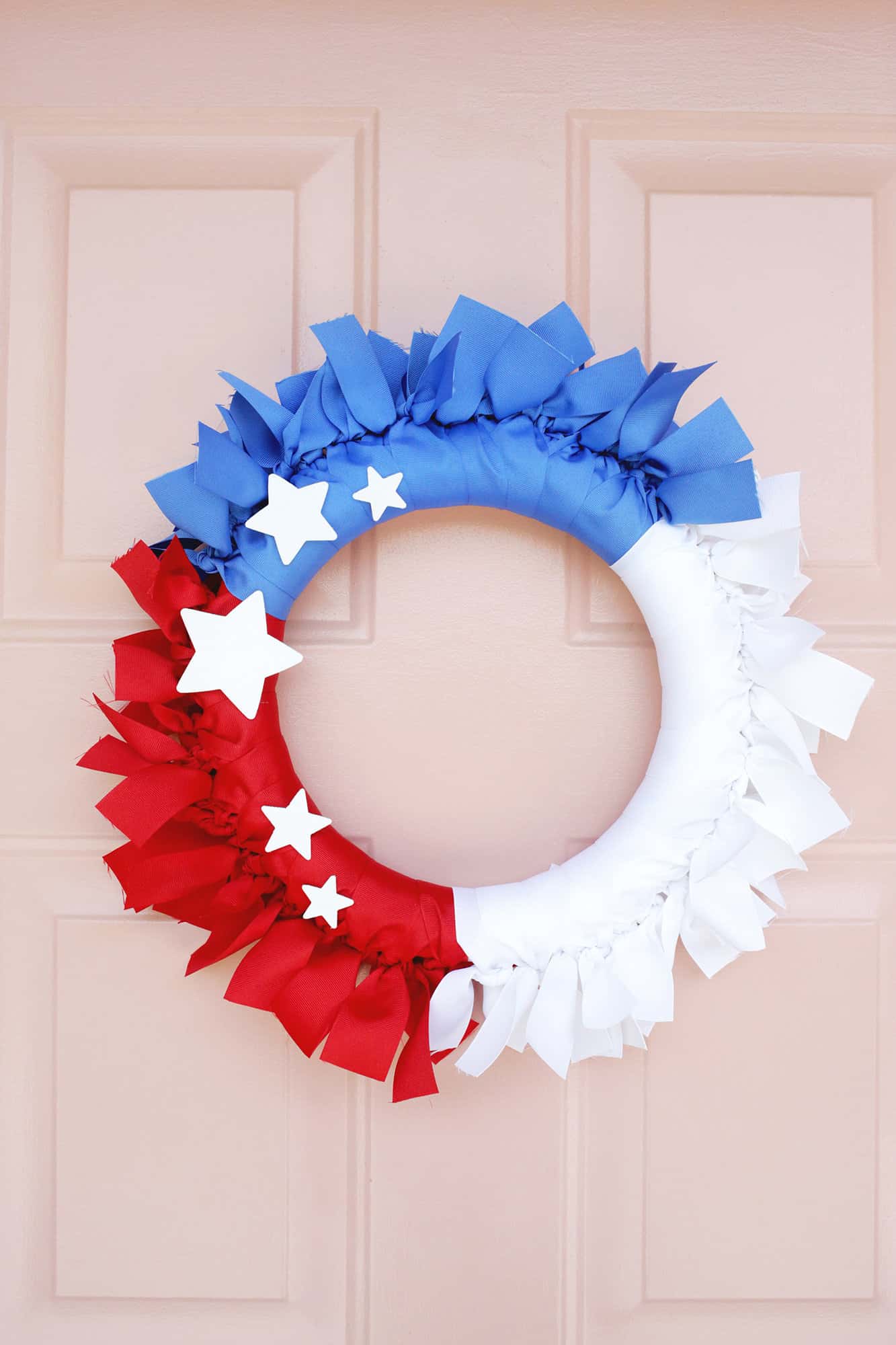 fourth of july ribbon wreath on pink door